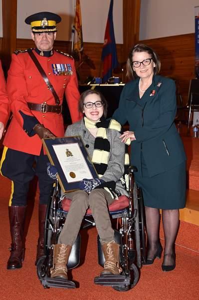 Becca Schofield with New Brunswick Lieutenant-Governor Jocelyne Roy-Vienneau and New Brunswick RCMP Commanding Officer A./Commr. LarryTremblay, receiving a Commander's Certificate of Appreciation for Outstanding Community Spirit and Leadership