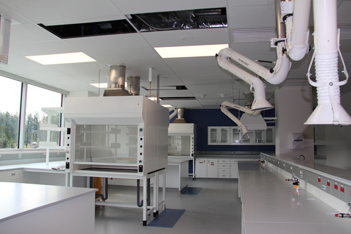 Salle de laboratoire avec armoires de rangement blanches et bras de ventilation spécialisés suspendus au plafond. (Toutes les photos fournies par Shane O'Connor)