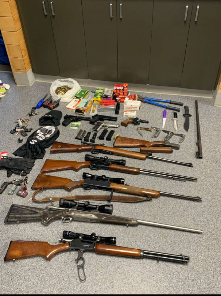 Bolt cutters, multiple knives, a machete, six rifles, three semi-automatic handguns with five loaded magazines, bags of ammunition, a revolver, a black ski mask and leather gloves