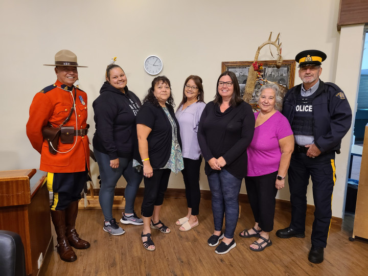 Cst. Jeff Chartrand (far left) and Cst. Serge Montreuil (far right) stand with members of Indigenous Services Canada during the Nipissing treaty annuity payment event