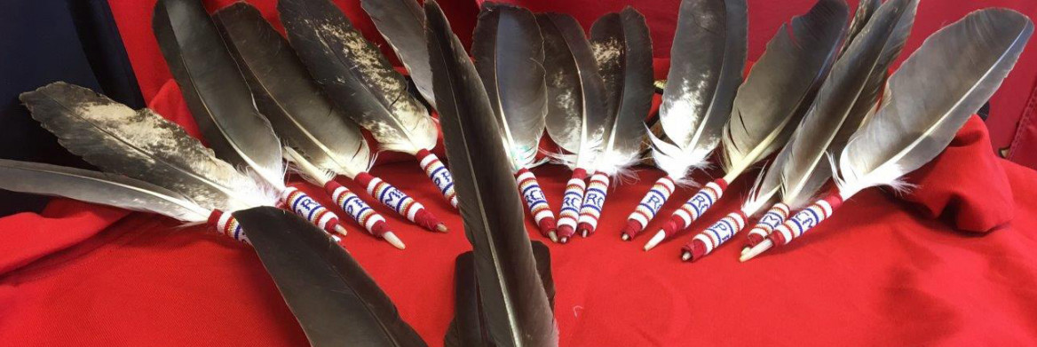 Eagle feathers with beaded handles.