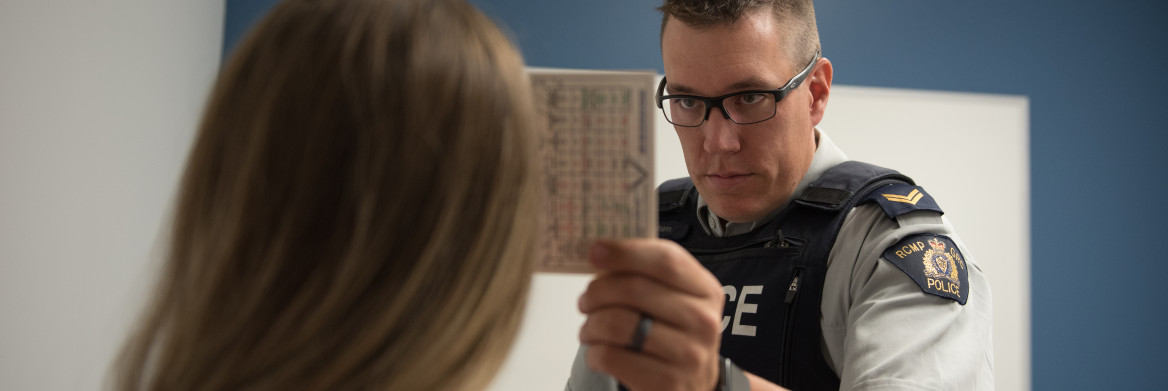 Police officer tests woman's eyesight.