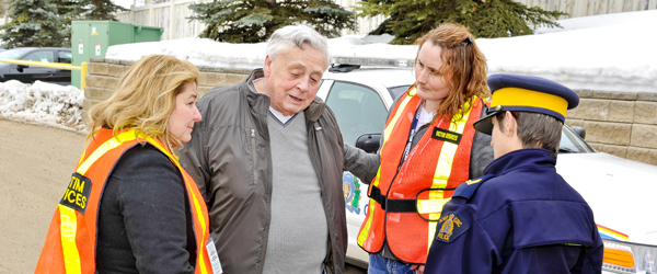 Victim Services volunteers helping an elderly man