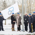 The RCMP Commissioner Brenda Lucki holds Bell Let's Talk flag alongside her colleagues in National RCMP Headquarters.