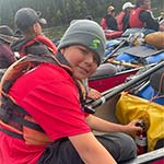Close-up of Yukon canoe trip youth in their canoes and safety gear while on the river