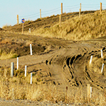 Rolling hills with dirt roads and steep corners.