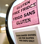 A sign on the top of a fridge, indicated it contains gluten-free food.