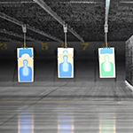 A row of shooting targets hang from the ceiling of the 100m range. 