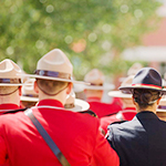 Cadets in red serge with Stetson hats on.  There is one cadet from another police agency with a black uniform on. 