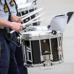 Cadets play snare drums.
