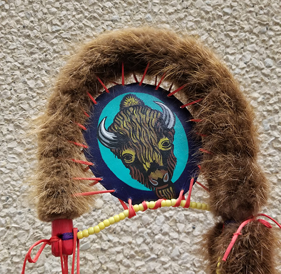 Close up photo of red feathers on the eagle staff