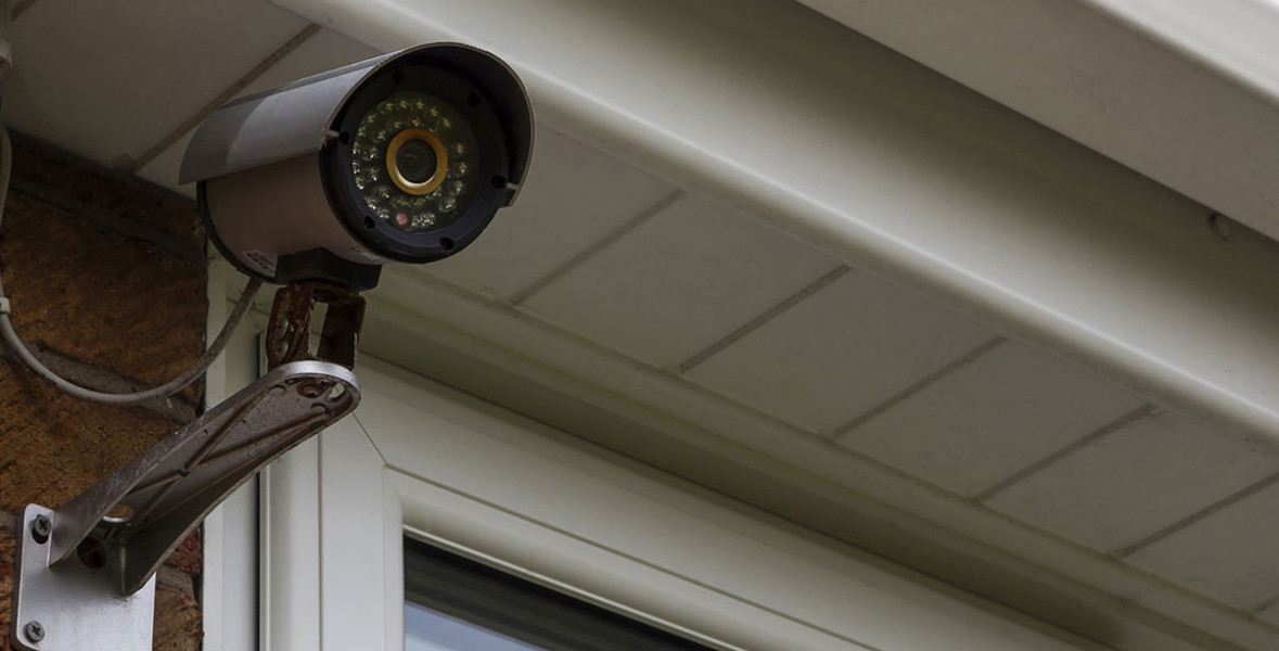 A security camera mounted outside a store.
