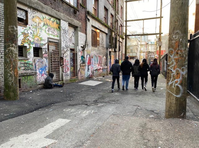 Group of Whati youth walking through alleys on East Hastings Street in downtown Vancouver