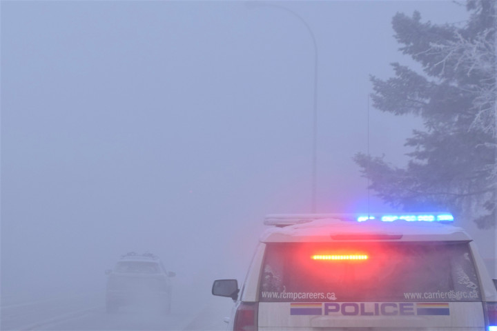 Police vehicle on Second Avenue amidst the ice fog.