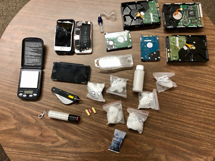 170.5 grams of suspected methamphetamine, drug paraphernalia, cell-phones, a scale, a pipe, hard drives, capsaicin dog spray and a knife