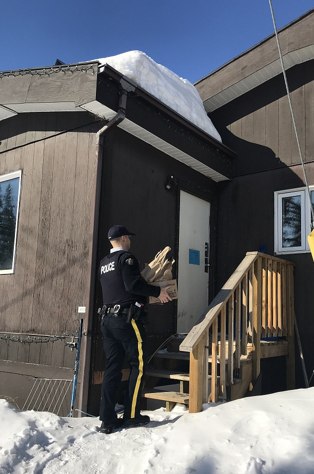 Photo of Old Crow RCMP officer delivering groceries to a residence