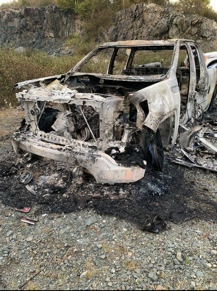 Police investigate a stolen black 2019 GMC Sierra found completely destroyed by fire on October 7, 2020.