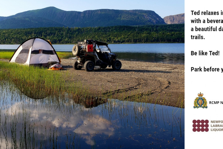 A tent is set up on a lake with an ATV parked beside it.