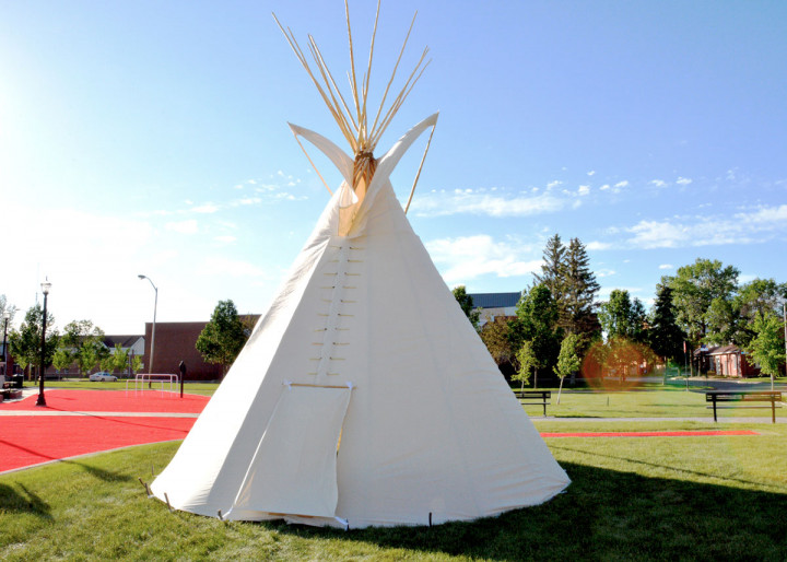 The finished mikiwahp (tipi) at Depot Division with a blue sky in the background.