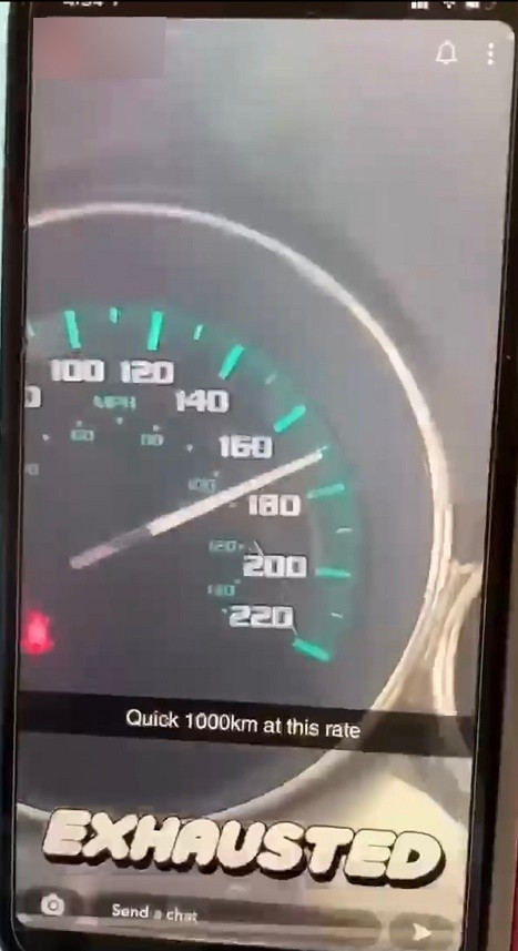 A screenshot of a Snap Chat video shows a vehicle travelling at a high rate of speed, with the seat belt warning illuminated. 