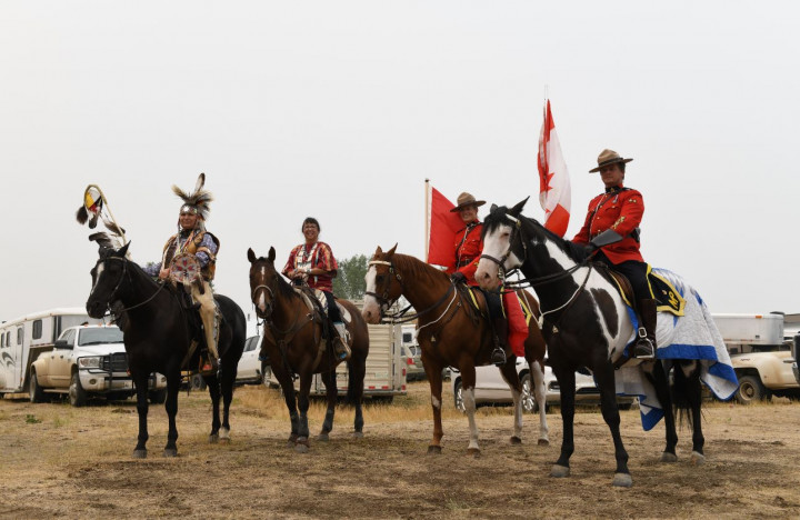 Councillor Stanley Lethbridge, Kim Soo Goodtrack, Constable Platford and Sergeant Silliker sit atop their horses as they wait for the day's opening ceremonies to begin