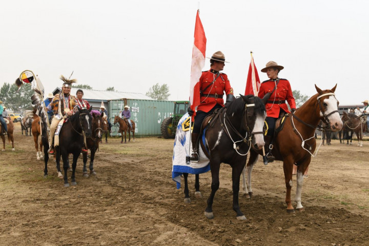 Councillor Stanley Lethbridge, Kim Soo Goodtrack, Constable Platford and Sergeant Silliker sit atop their horses and wait outside the arena until the ceremonies begin