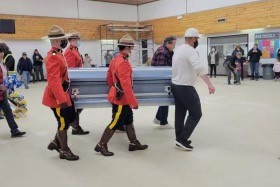 Officers in Red Serge carry Richard Montgrand's casket at his funeral