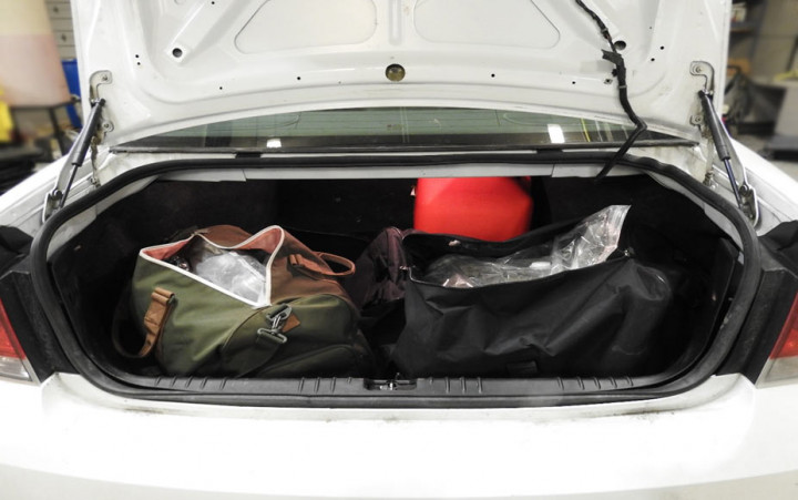 (RCMP photo) 6.8kg of unstamped cannabis that was seized as part of a CRTF investigation. The packages of cannabis are pictured in duffle bags in the trunk of the suspect's car.