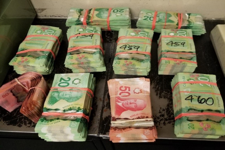 (RCMP Photo 2 of 3) Canadian currency seized by the RCMP during the investigation.