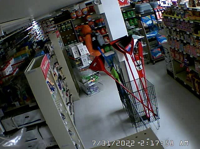 Person in orange jacket inside store