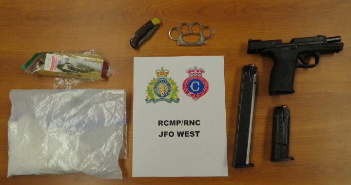 Various items, including a handgun and a baggie containing a white substance, are shown laid on a desktop around a sign that reads RCMP-RNC JFO West Drug Unit.