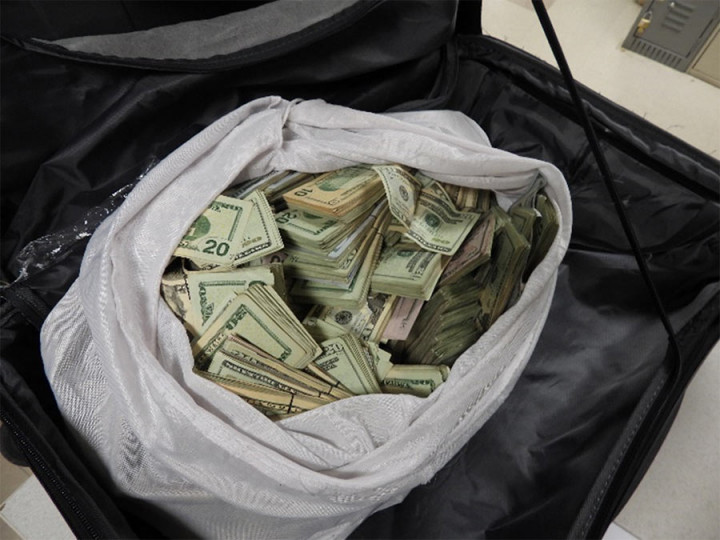 Money concealed in a suitcase and a safe