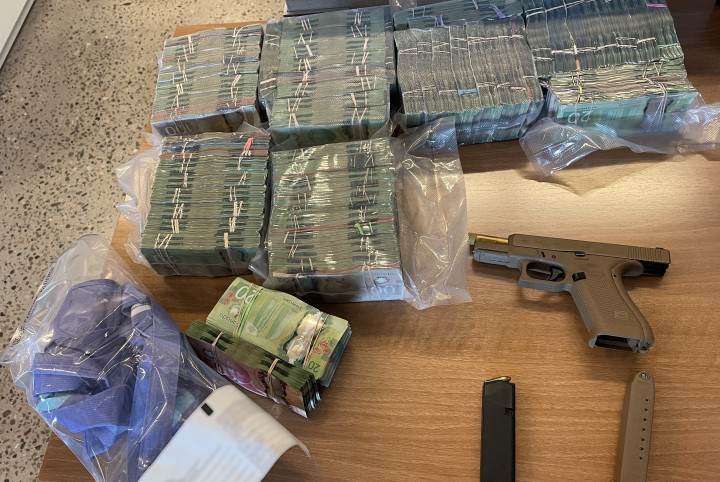 Large quantity of Canadian currency, a restricted firearm and ammunition