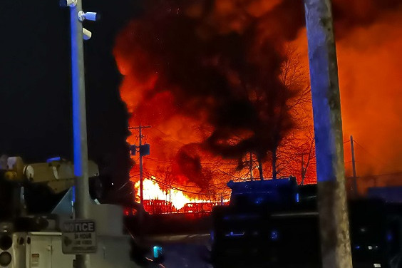 A large fire is observed in a commercial area at night.