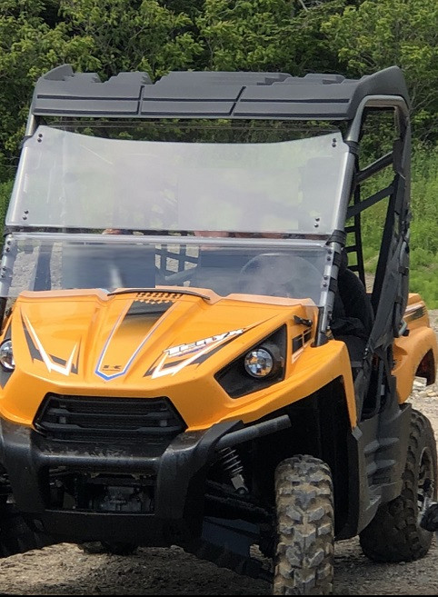 An orange 2013 Kawasaki Teryx.
