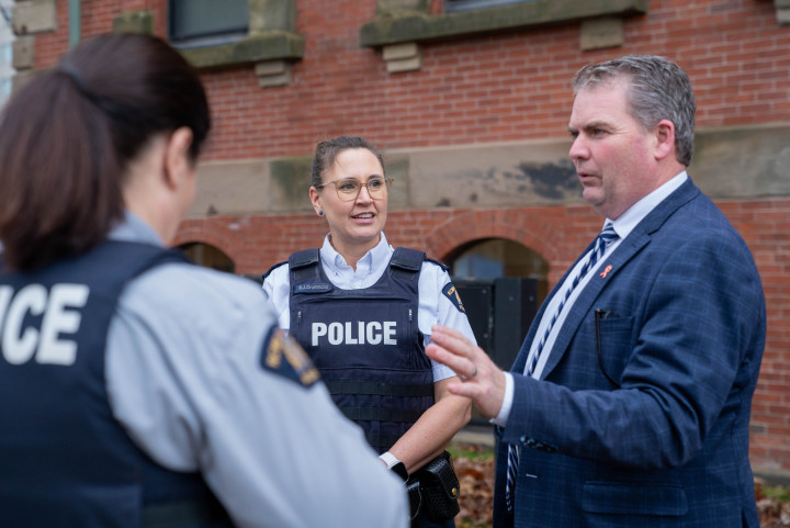 Minister Thompson chats with Superintendent Drummond and Constable Hodder