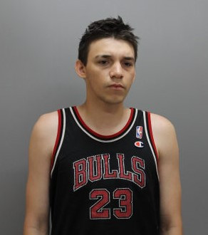 Keaton Nicotine is described as approximately 6' tall and 180 lbs. He has brown hair and brown eyes. 