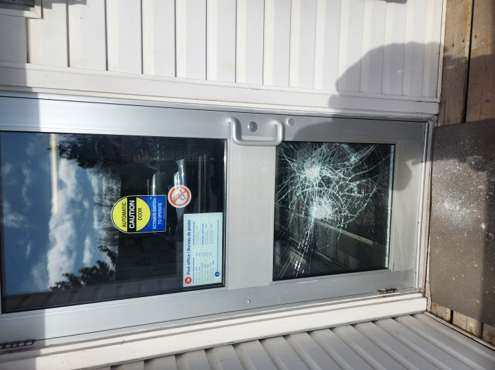 A door with its glass window smashed.
