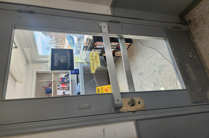 A door with its glass window smashed.