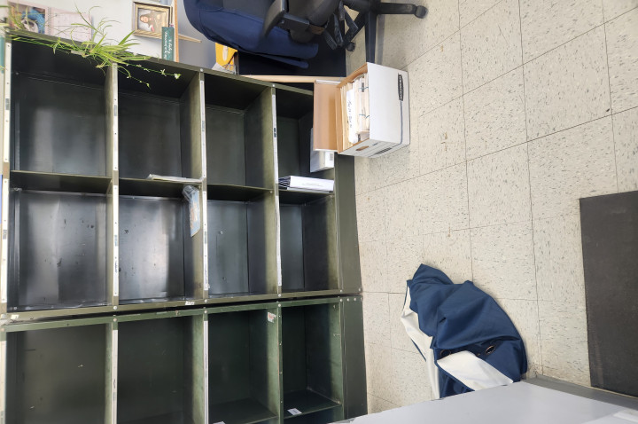 The inside of the post office; empty shelves. 