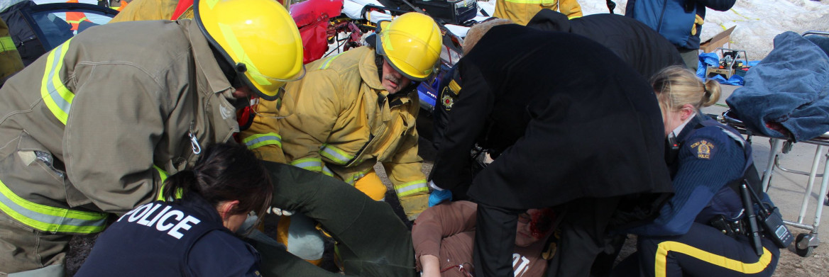 First responders place a young woman in a body bag.