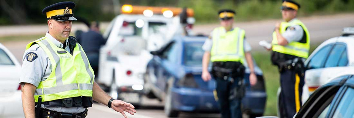 Three RCMP officers carry out traffic checks.
