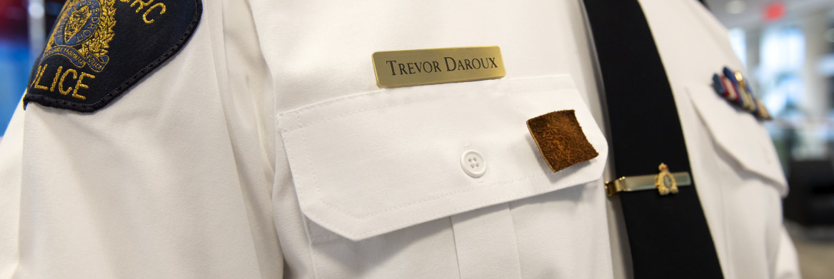  Small square of moose hide pinned on a police officer's white shirt.