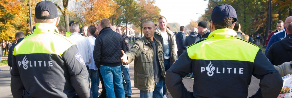 Um homme se dispute avec deux policiers.